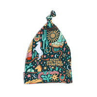 The SoftKnot Cap in Wild West print, bamboo newborn hat with a cozy knot for gentle, non-scratch fit.