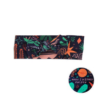 SoftKnot Bow in Desert Cactus (Midnight) navy fabric with desert print, styled as a baby head-wrap.