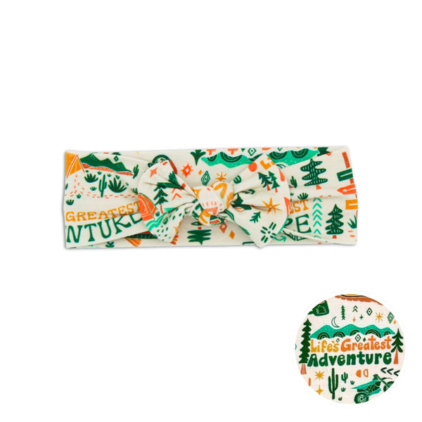 Headband with nature-themed design and text on a white background