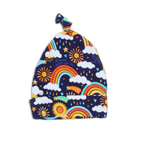 The SoftKnot Cap Here Comes the Sunshine (Blue): bamboo newborn cap with sun and rainbow print for comfy, gentle wear.
