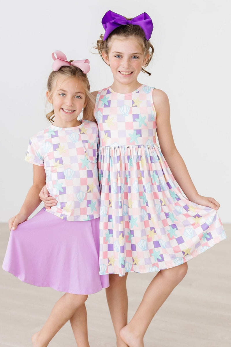 Little girl joyfully spinning in the Beach Days Tank Twirl Dress by Mila & Rose, emphasizing the dress's twirl-friendly design.