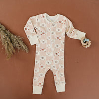 GOTS certified organic cotton zippy romper featuring a checkered bear print. Chemical-free baby clothing with full-length zipper and soft cuffs.