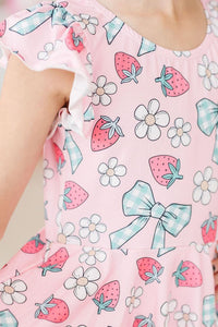 Berry Picnic Short Sleeve Twirl Leotard in pink with strawberry and daisy print and blue gingham bows.