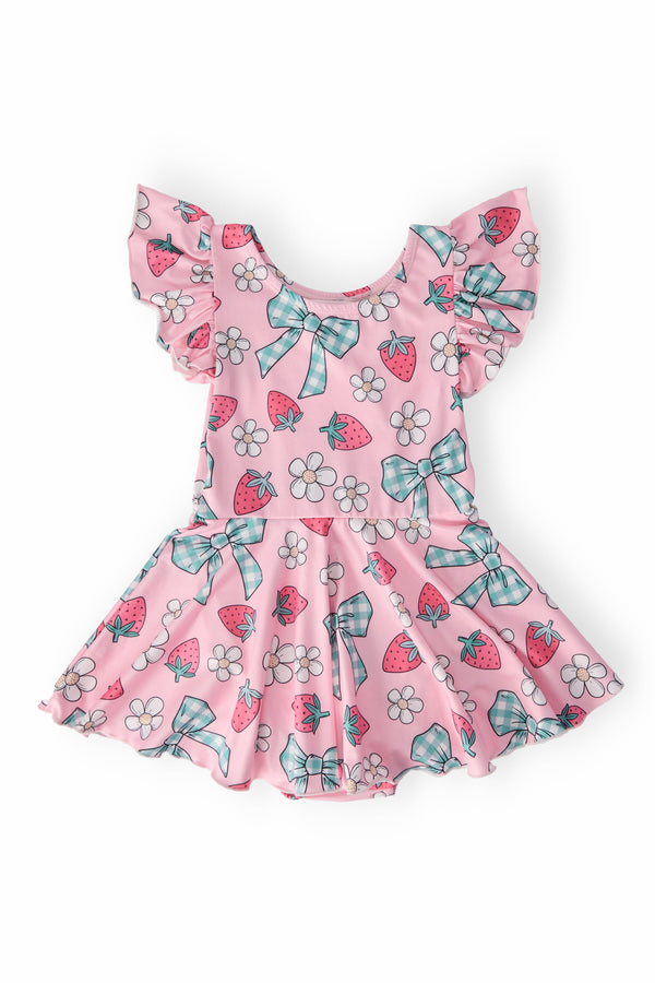 Berry Picnic Short Sleeve Twirl Leotard in pink with strawberries, daisies, teal bows, and ruffled sleeves.