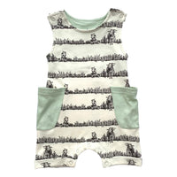 GOTS certified organic cotton sleeveless romper featuring a black grazing animal print and mint green pockets. Chemical-free baby fashion.