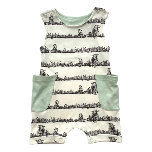 GOTS certified organic cotton sleeveless romper featuring a black grazing animal print and mint green pockets. Chemical-free baby fashion.