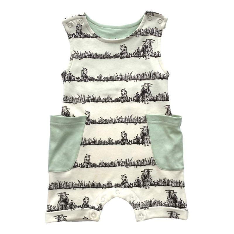 GOTS certified organic cotton sleeveless romper featuring a black grazing animal print and mint green pockets. Chemical-free baby fashion.