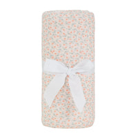 knit blanket in cream with pink and green floral pattern made from soft breathable material