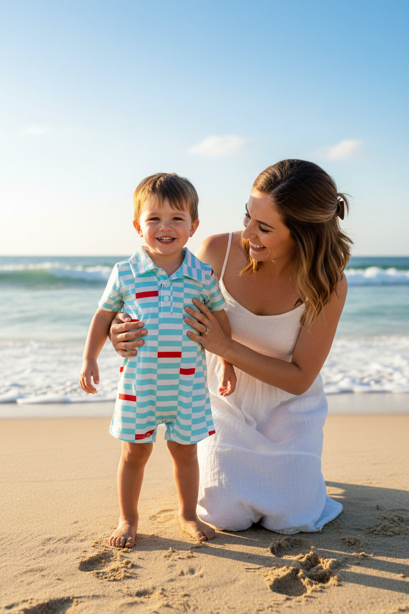 Baby romper with blue and white stripes and red accents on a white background