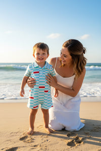 Baby romper with blue and white stripes and red accents on a white background