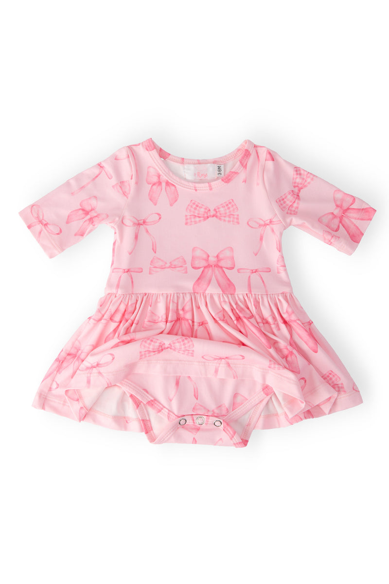 Baby playing joyfully in the Blushing Bows 3/4 Sleeve Twirl Bodysuit by Mila & Rose, perfect for twirling and fun.