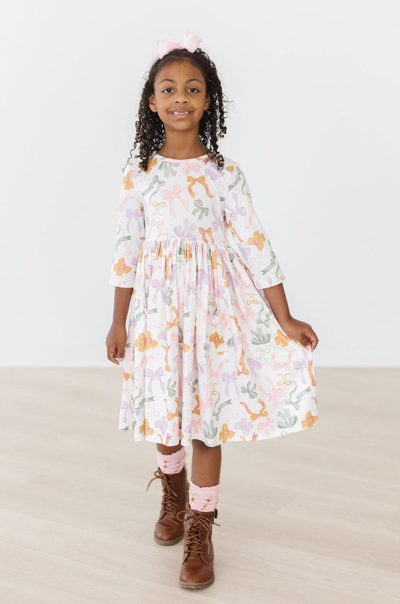 Group of children wearing the Boho Bows 3/4 Sleeve Pocket Twirl Dress, illustrating the dress's playful appeal and twirl capabilities.
