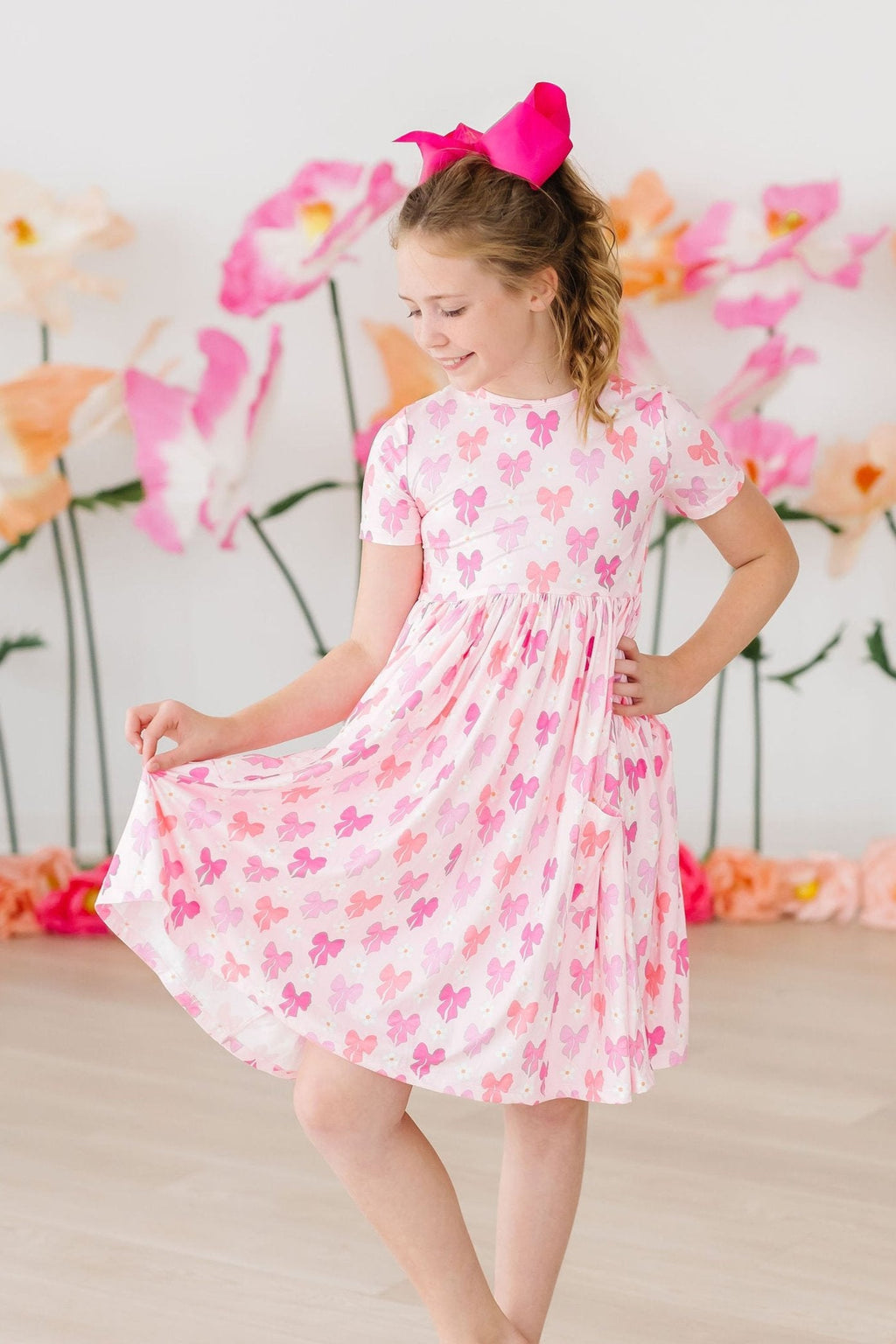 Bow Beauty S/S Pocket Twirl Dress in vibrant colors, featuring a twirling design perfect for little girls' playtime and special occasions.