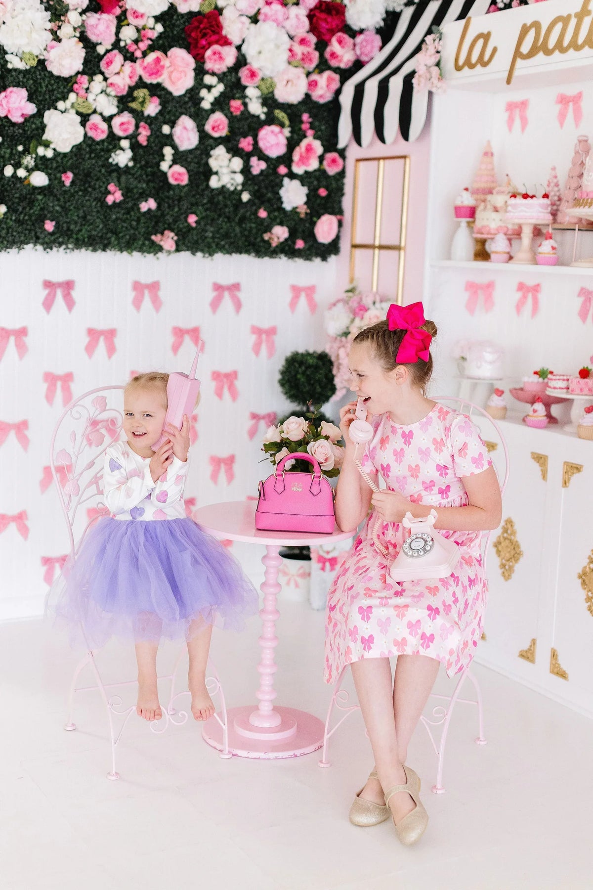 Girls pink bow twirl dress for girls with butterfly print, short sleeve, worn by child at tea party