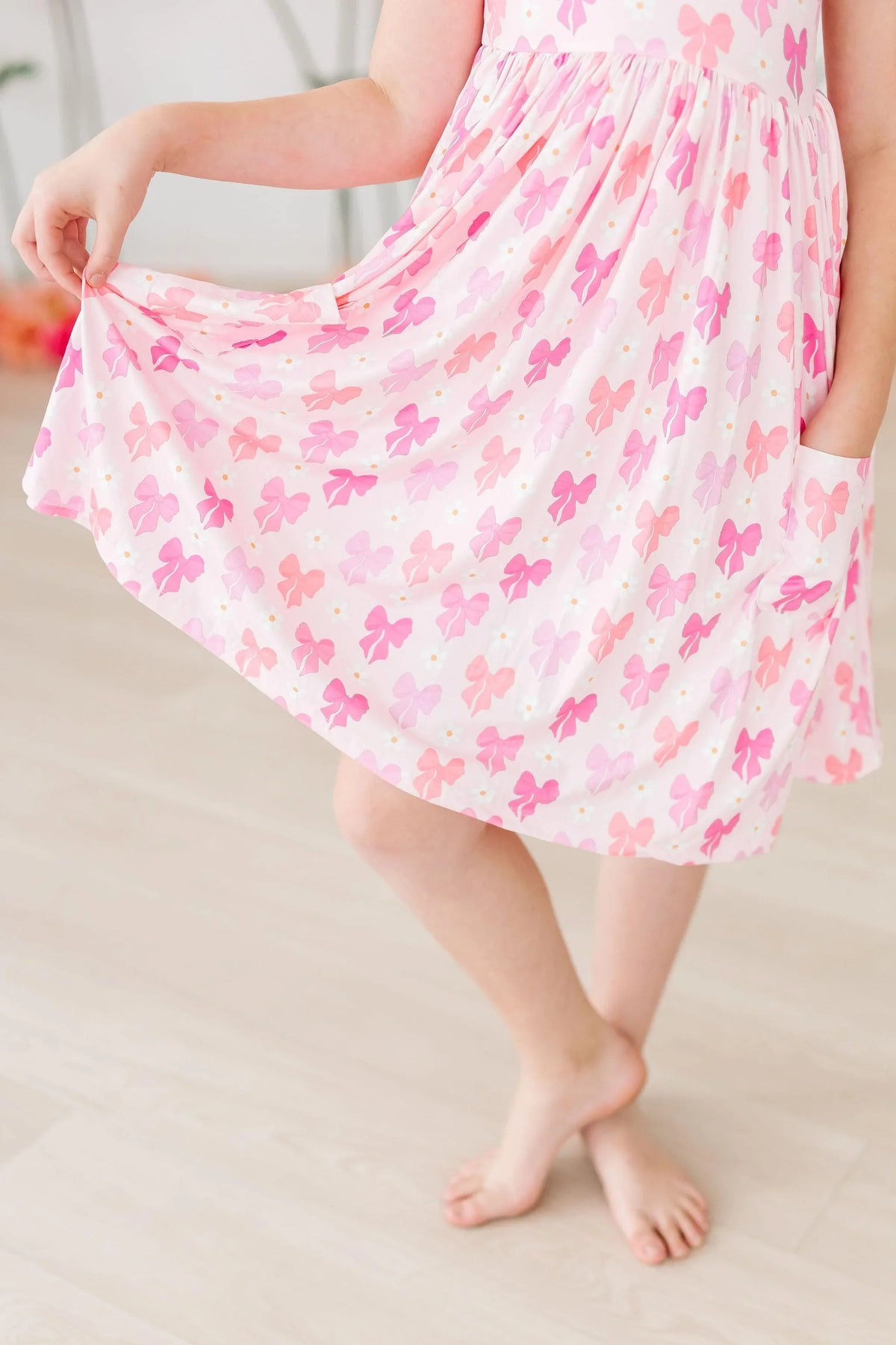 Girls pink bow twirl dress for girls with short sleeves and butterfly print, age 4-6