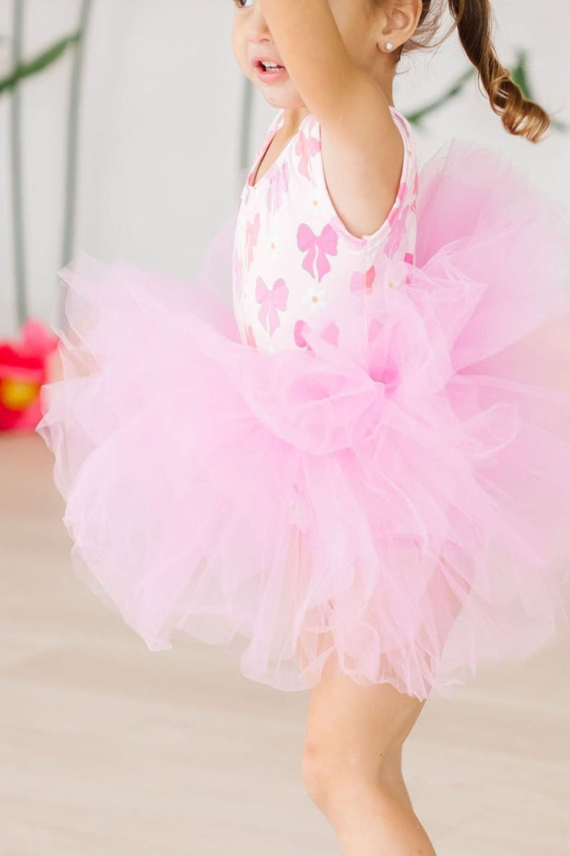 Happy child wearing the Bow Beauty Tank Tutu Leotard during playtime, showcasing its vibrant colors and joyful flair.