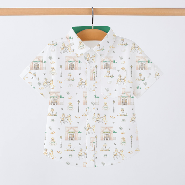 White shirt with small pattern on a wooden hanger against a white background