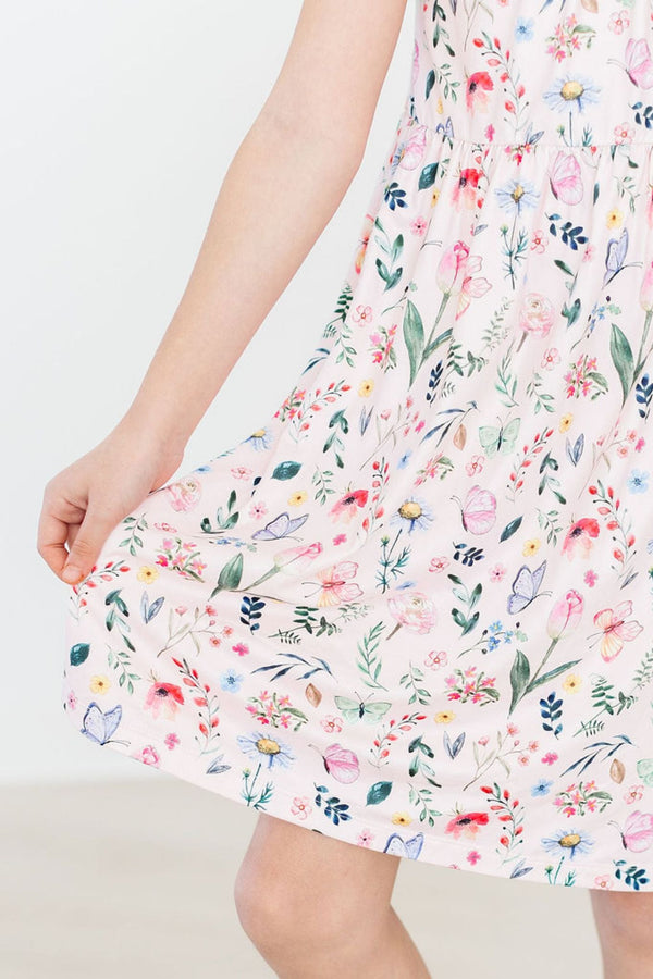 Butterfly Meadows Ruffle Cross Back Dress in pastel floral print with crisscross back straps and shoulder ruffle.