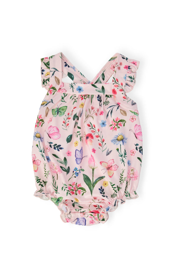 Butterfly Meadows Ruffle Cross Back Romper in pink floral print with crisscross back straps and shoulder ruffle.