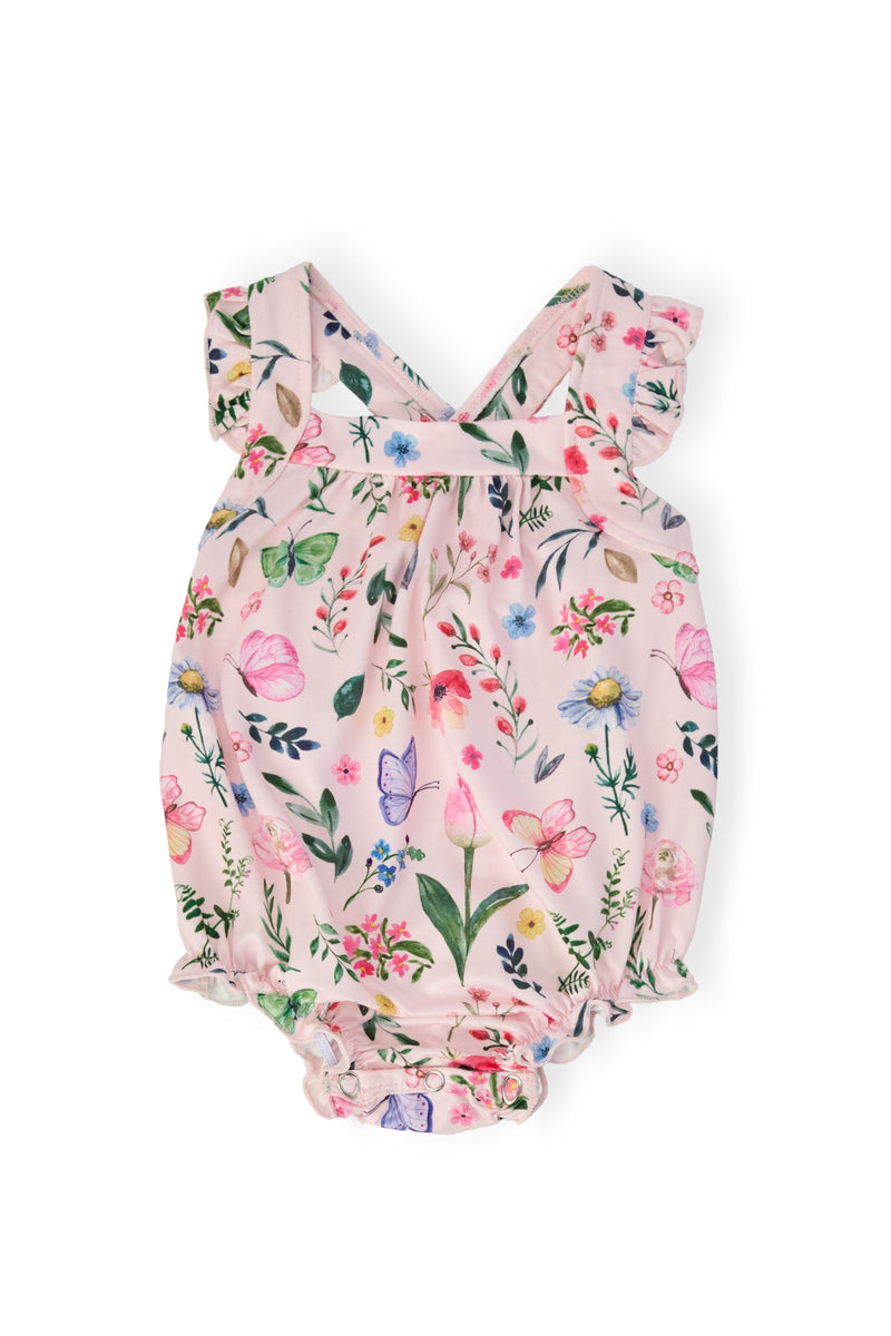 Butterfly Meadows Ruffle Cross Back Romper in pink floral print with crisscross back straps and shoulder ruffle.
