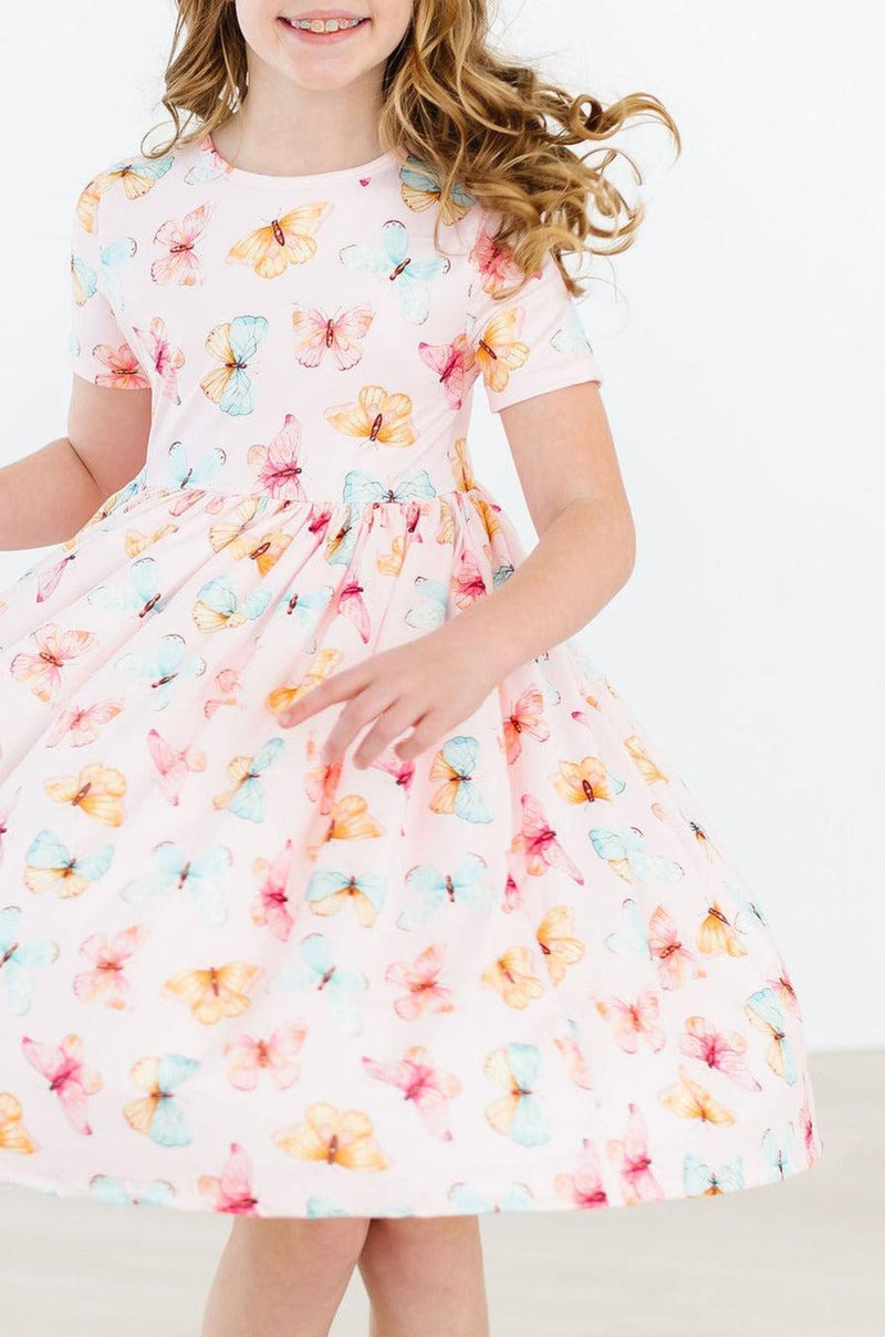 Stylish scoop back of the Butterfly Kisses S/S Pocket Twirl Dress for Girls, perfect for easy wear and endless play.