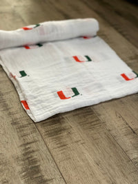 University of Miami Hurricanes Muslin Swaddle Blanket – Soft Breathable Baby Blanket – Officially Licensed The U Newborn Gift - The Palm Beach Baby
