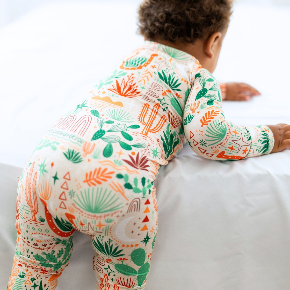 Child wearing Desert Cactus beige Second-Skin Convertible Romper with cactus print.