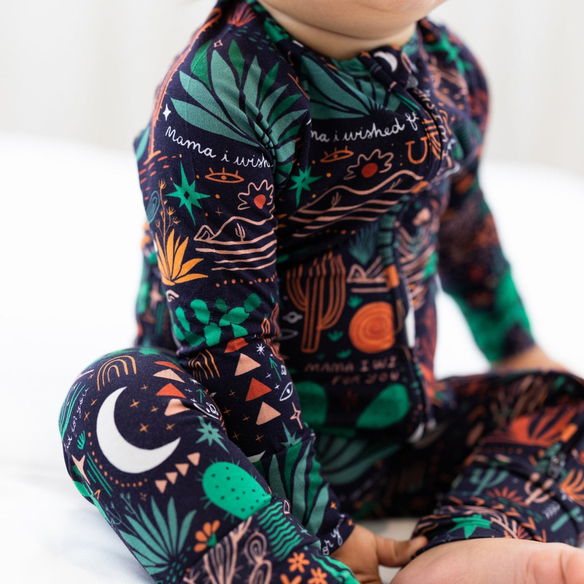The Second-Skin Convertible Romper | Desert Cactus (Midnight) worn by baby; two-way zip, soft viscose from bamboo.