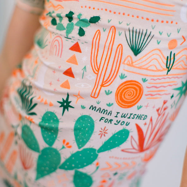 Beige Desert Cactus two-piece pajama fabric with green cacti and orange accents.
