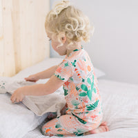 Toddler wearing The Second-Skin 2-Piece Short Sleeve Pajama in Desert Cactus beige with cactus print.