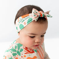 SoftKnot Bow beige Desert Cactus head-wrap on a baby, showcasing colorful cactus and desert print.