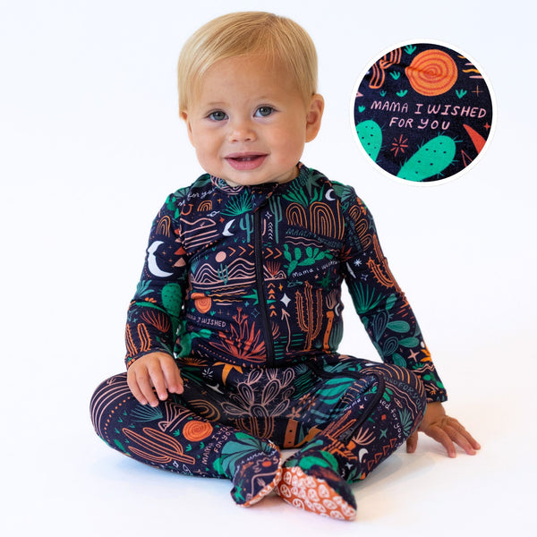 Baby wearing The Second-Skin Footie | Desert Cactus (Midnight) with print that reads Mama, I Wished for You.