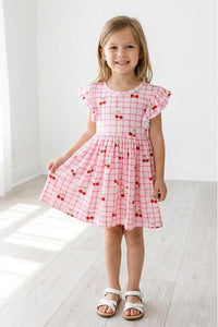 Cherry Sweet Flutter Sleeve Twirl Dress for Girls worn at a family gathering, ideal for stylish comfort.