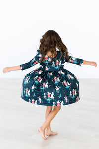 Girl twirling in dark teal Christmas ballet dress with胡桃scout print, 3/4 ruffle sleeves, and full skirt for festive play.
