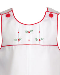 White cotton pique boy's outfit with red trim, pleated yoke, and hand-embroidered holly and berries for Christmas.