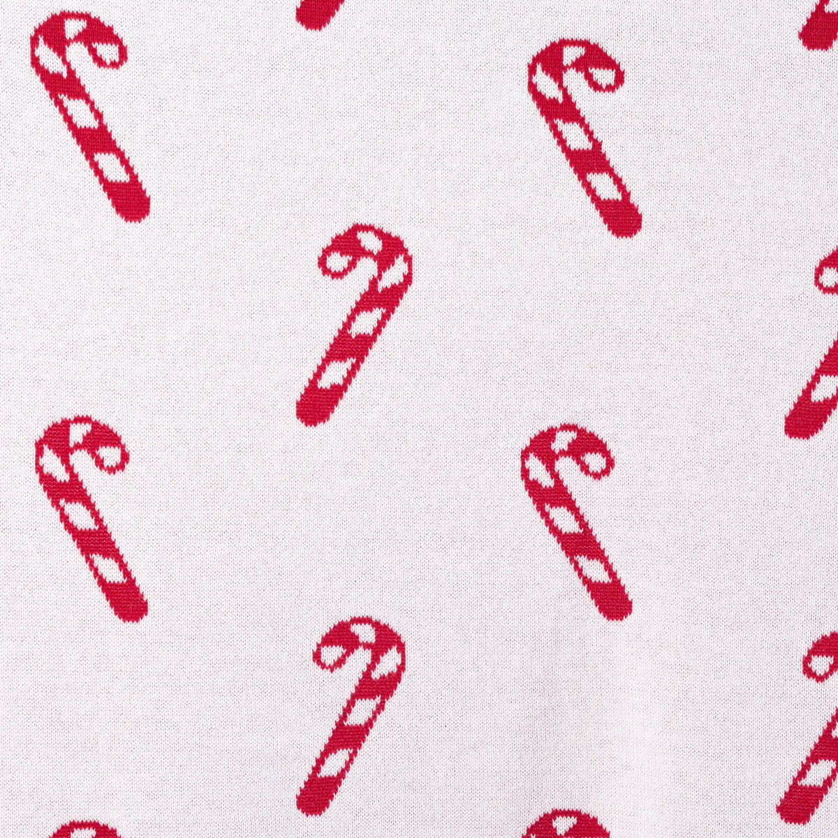Extreme close up of white reverse side showing intricate knit weave and red motifs