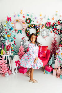 Mila wears Cocoa Kisses Long Sleeve Pocket Twirl Dress with scoop back, ballet neckline, full twirling skirt.
