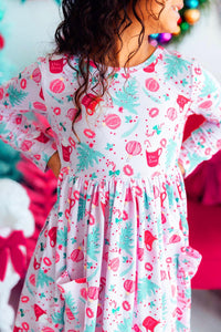Cocoa Kisses Long Sleeve Pocket Twirl Dress worn by a girl; pastel holiday print, full twirl-ready skirt.