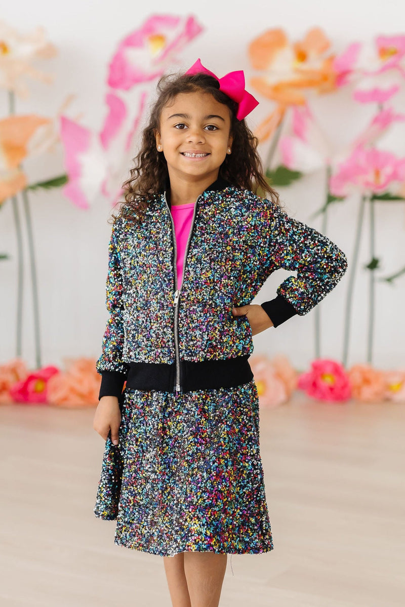 Close-up of the dazzling sequins on the Confetti Sequin Jacket, reflecting light and capturing the spirit of fun and creativity.