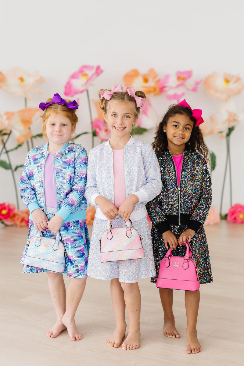 Three girls wearing colorful Cotton Candy Sequin Jackets for Girls with zippered fronts, showcasing a fun and stylish look. Perfect for parties and playdates, these jackets add sparkle and charm to any outfit.