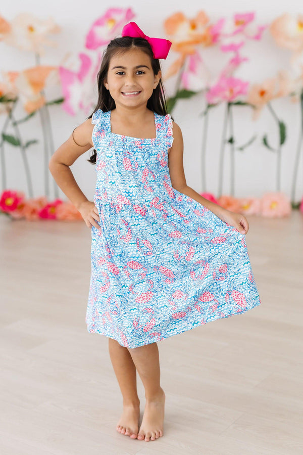 Adorable Crab Walk Ruffle Cross Back Dress for Girls featuring playful crisscross straps and charming ruffles, ideal for summer twirling.