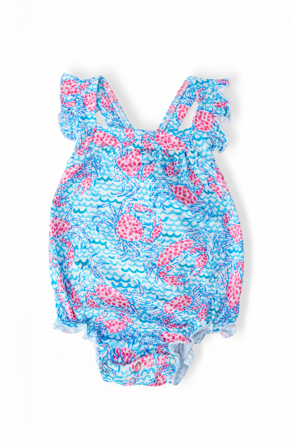 Crab Walk Ruffle Cross Back Romper in blue pink print with crisscross back straps and diaper snaps.