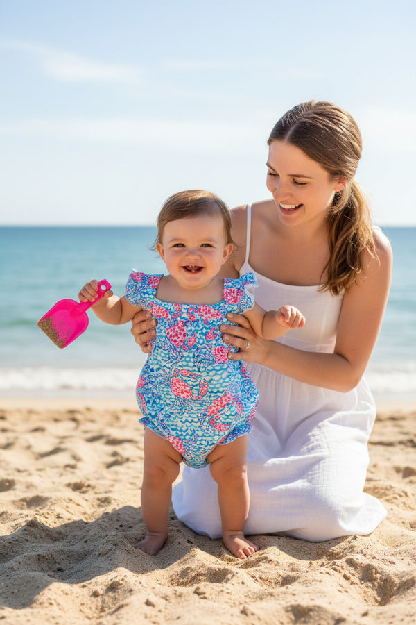 Baby girl's floral swimsuit with ruffles on a white background