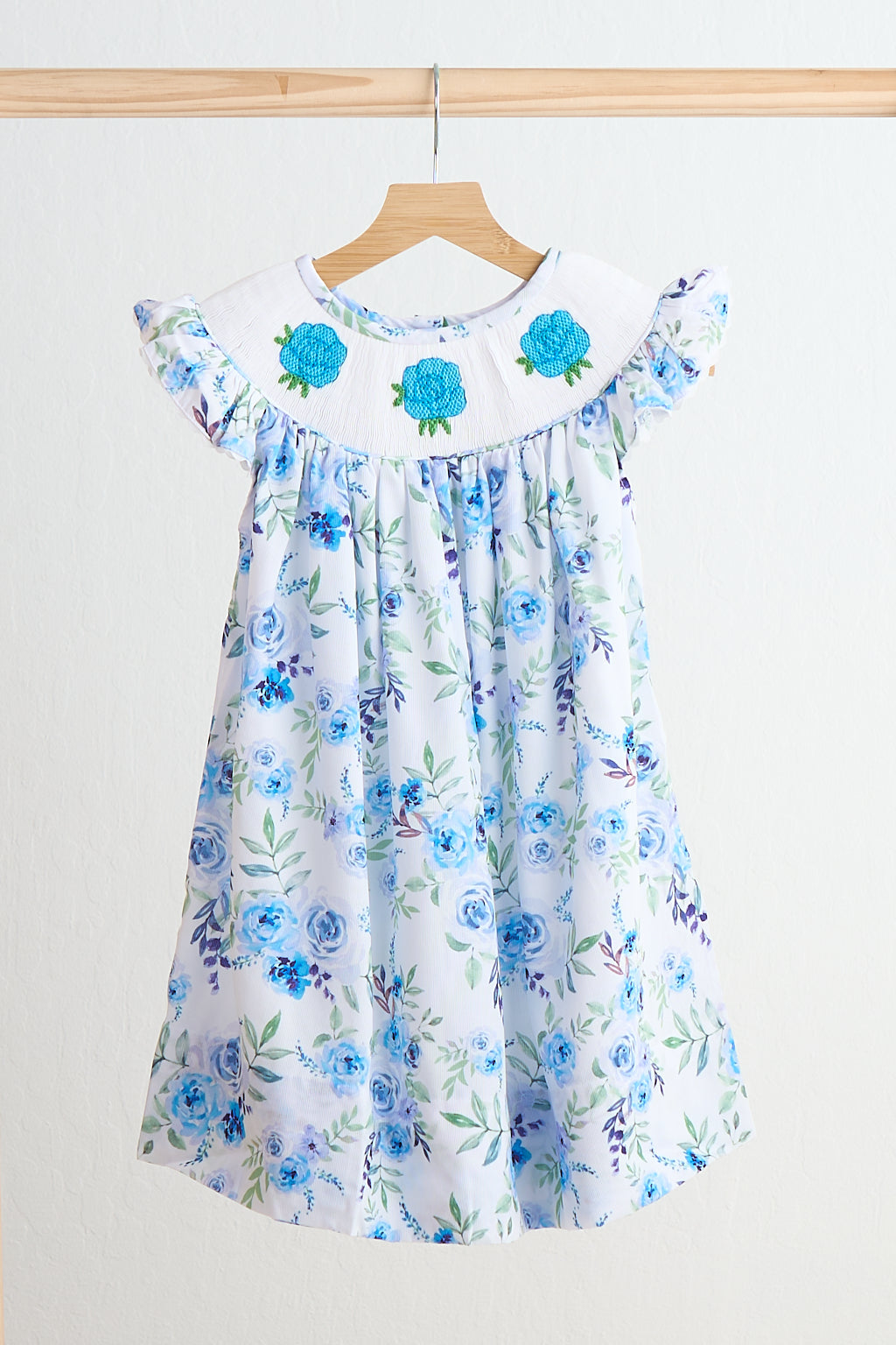 Blue rose hand smocked print dress with floral motif collar, ruffled sleeves, and breathable cotton blend fabric for girls.