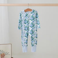Hydrangea Heaven organic cotton kids pajama set with blue hydrangea print on a wooden hanger