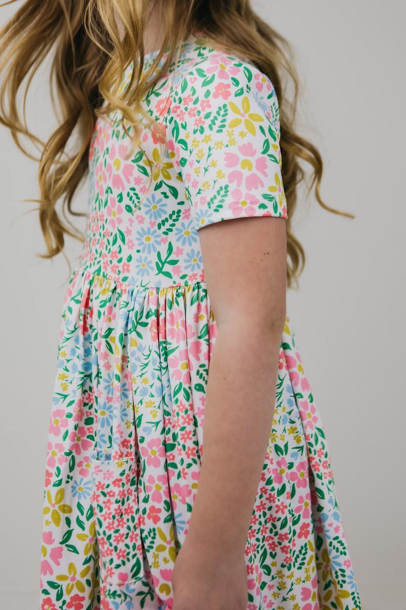 A glimpse of the vibrant Daffodils S/S Pocket Twirl Dress for Girls flaunting its playful twirl, crafted for comfort and style.