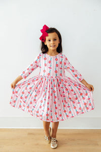 Coastal elegance of the Daisy Chain Three Quarter Sleeve Pocket Twirl Dress displayed on a little girl, showcasing the fun twirling action of this girls pocket twirl dress.