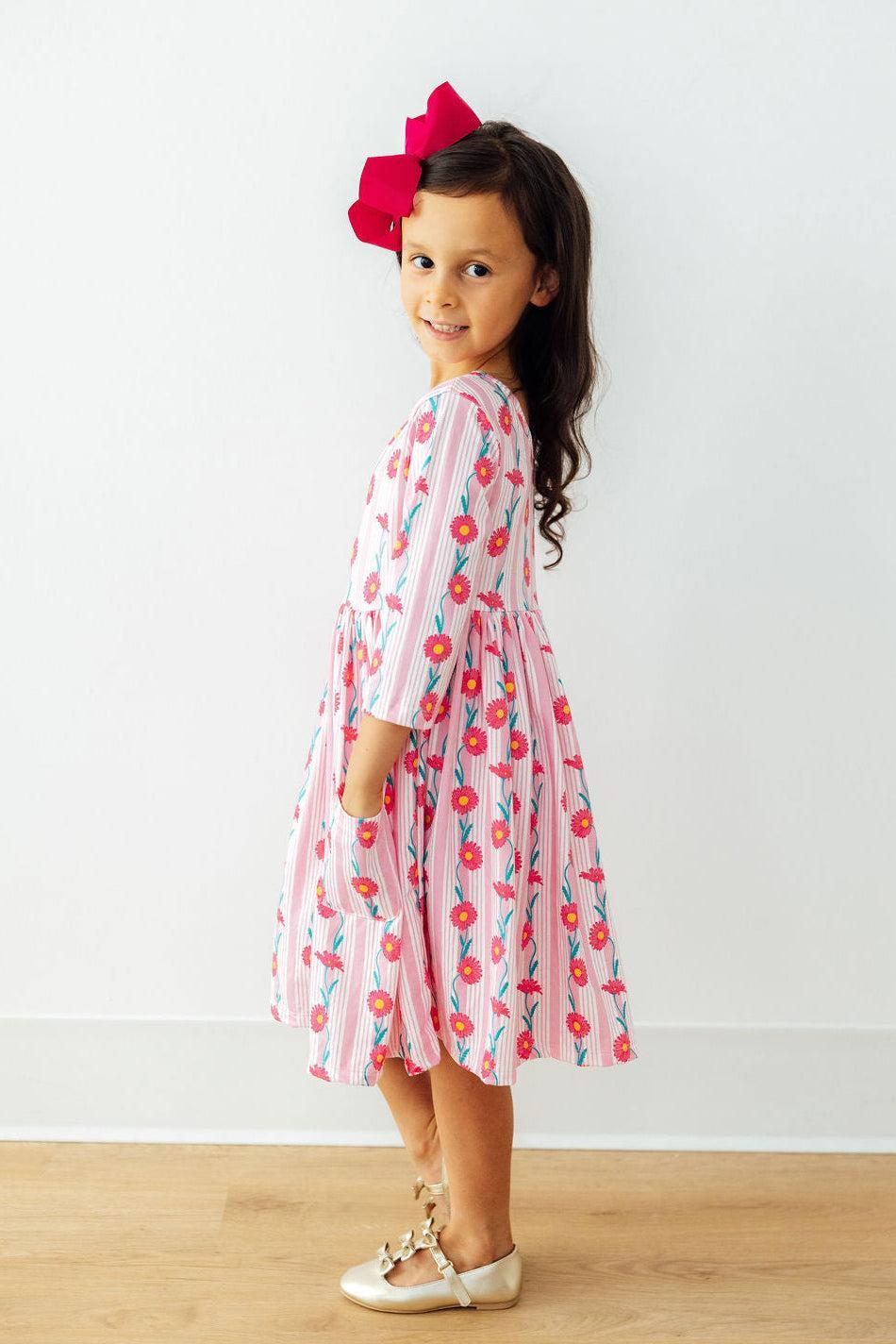 Close-up of the Daisy Chain Three Quarter Sleeve Pocket Twirl Dress with a scoop back and ballet neckline, emphasizing its features as a girls pocket twirl dress.