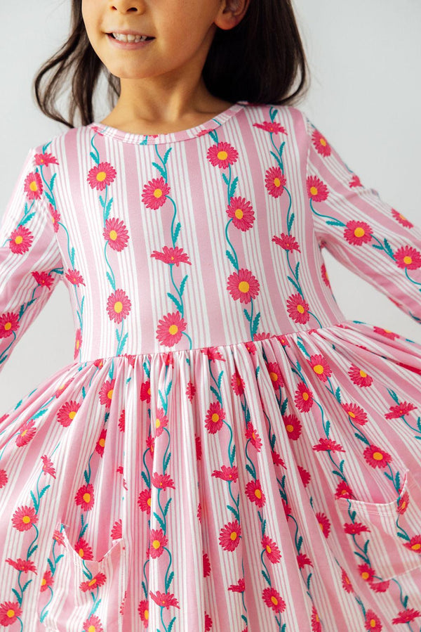 Daisy Chain Three Quarter Sleeve Pocket Twirl Dress for girls, featuring a vibrant print and playful twirl skirt, perfect as a girls pocket twirl dress.