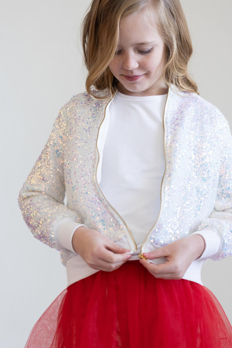 Girl adjusting the zipper of the SALE Disco Sequin Jacket by Mila & Rose, featuring a radiant design ideal for fun and fashionable outings.